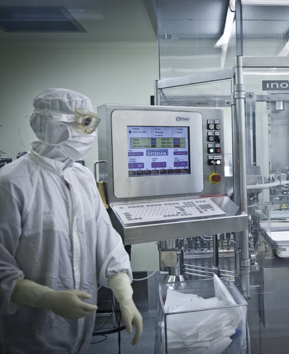 Gowned worker in sterile manufacturing environment
