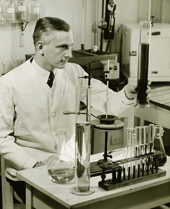 Scientist examining product in Baxter's earlier days